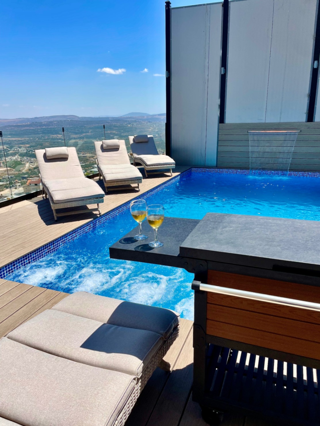 Private pool with cushioned loungers