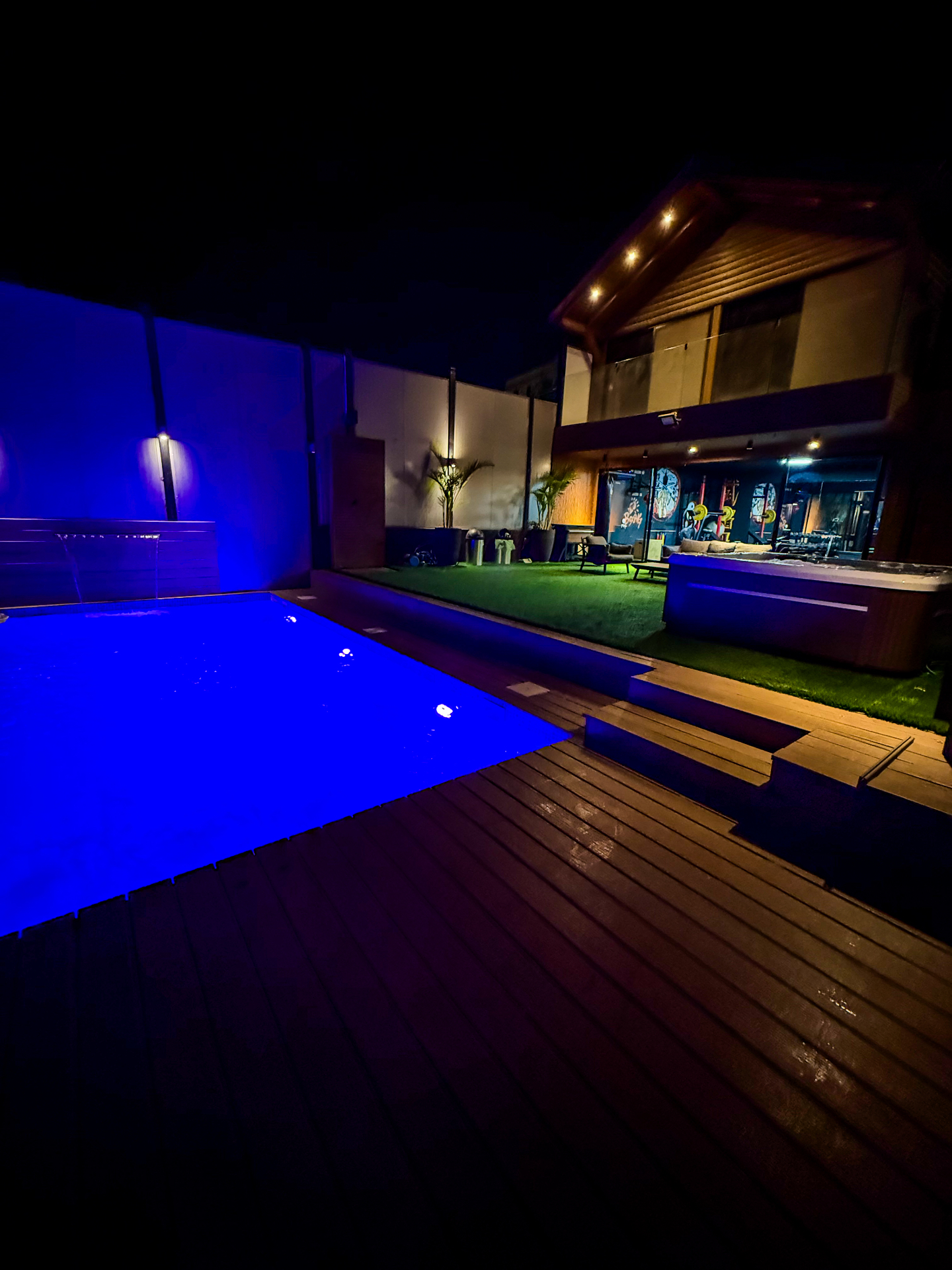 Blue-lit pool and timber deck